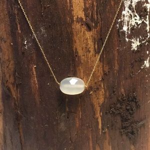 Delicate gold chain with faceted oval stone bead.